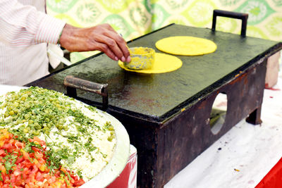 Midsection of person preparing food on table