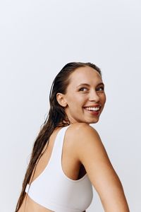 Portrait of young woman against white background