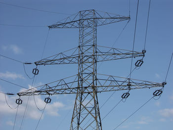 Low angle view of electricity pylon against sky