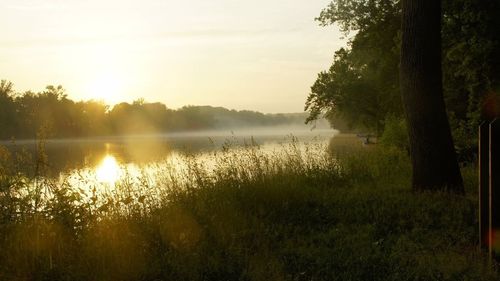 Scenic view of lake against sky during sunset