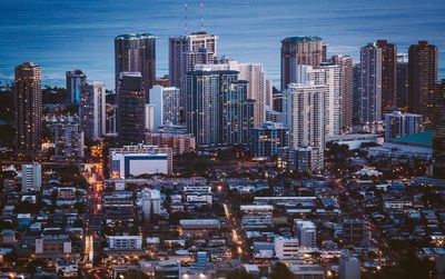 High angle view of city lit up at night