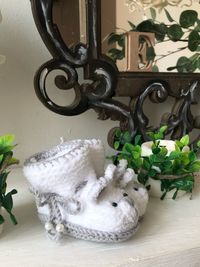 Close-up of white cat sitting on table at home