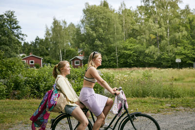Two friends riding bicycle