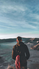 Man standing by sea against sky