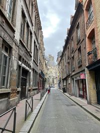 Street amidst buildings in city against sky