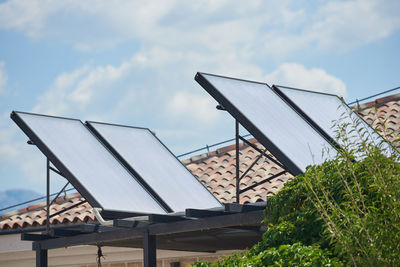 Solar panels on field against sky