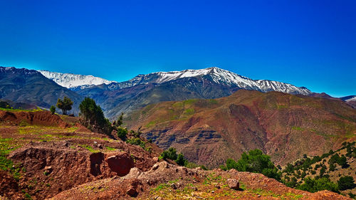 Scenic view of mountains against clear blue sky