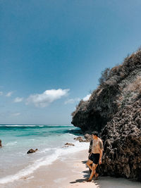 People on beach against sky