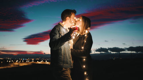 Lovely couple at sunset with fairy light