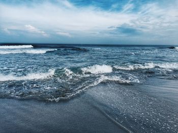 Scenic view of sea against cloudy sky