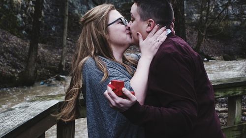 Side view of young couple kissing in winter