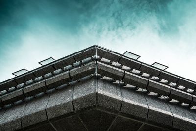 Low angle view of building against cloudy sky