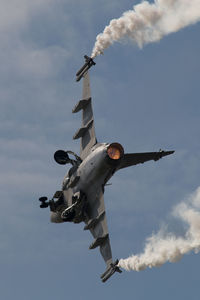 Low angle view of airplane flying against sky