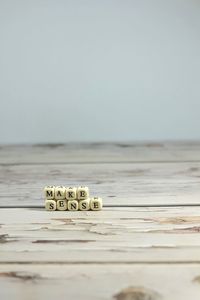 Surface level of wooden table against clear sky