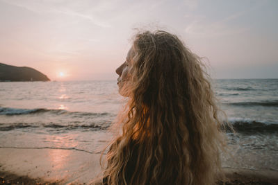 Woman at beach during sunset