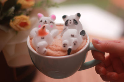 Close-up of hand holding coffee cup