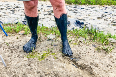 Low section of man walking on dirt