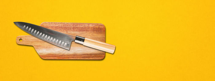 High angle view of pencils on table against yellow background