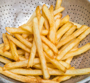 Close up french fries on a wooden background