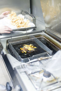 Midsection of person preparing food in kitchen