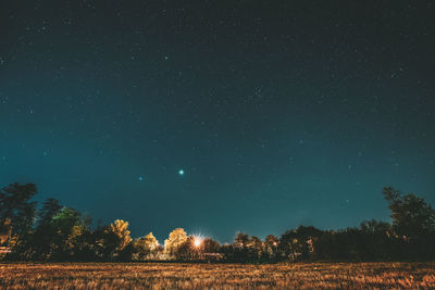 Scenic view of field against sky at night