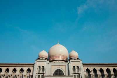 Low angle view of built structure against blue sky