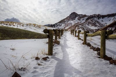 Snow covered landscape against sky