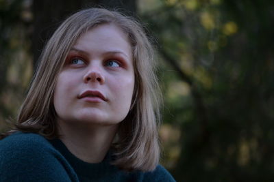 Close-up of young woman looking away