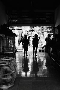 Rear view of men walking on footpath