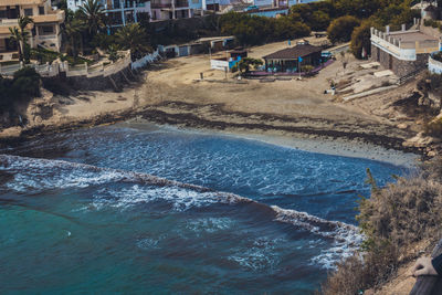 High angle view of buildings by sea