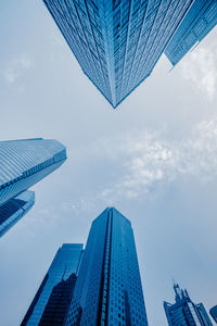 Low angle view of buildings against cloudy sky