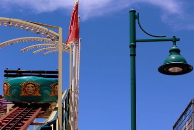 Low angle view of cross against blue sky