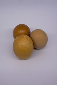Close-up of eggs against white background