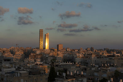 Israel, bat yam, residential district at dusk with two tall skyscrapers in background