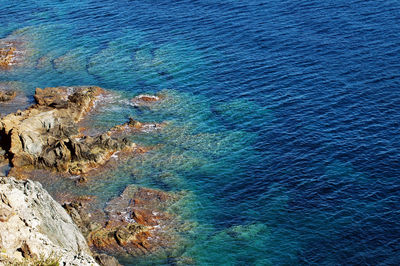 High angle view of sea by rocks at beach