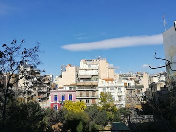Low angle view of buildings against blue sky