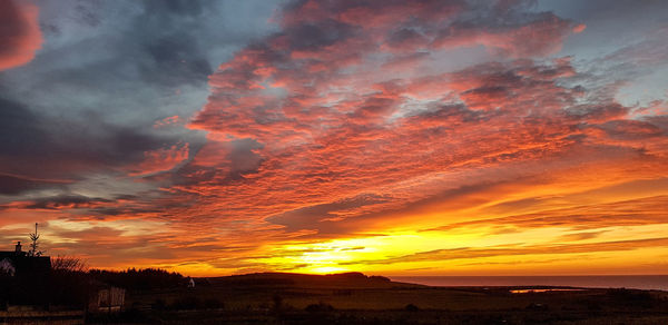 Scenic view of dramatic sky during sunset