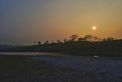 Scenic view of sea against clear sky during sunset