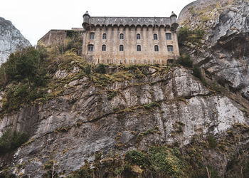 Low angle view of building against mountain