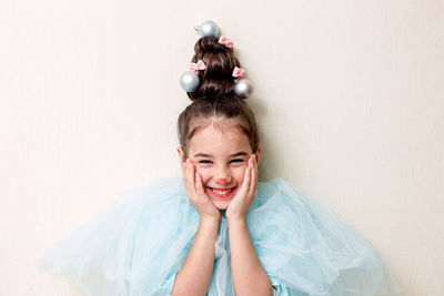 Portrait of funny girl with a hairstyle in the form of a christmas tree