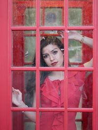 Portrait of girl looking through window