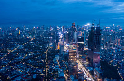 High angle view of illuminated city buildings at night