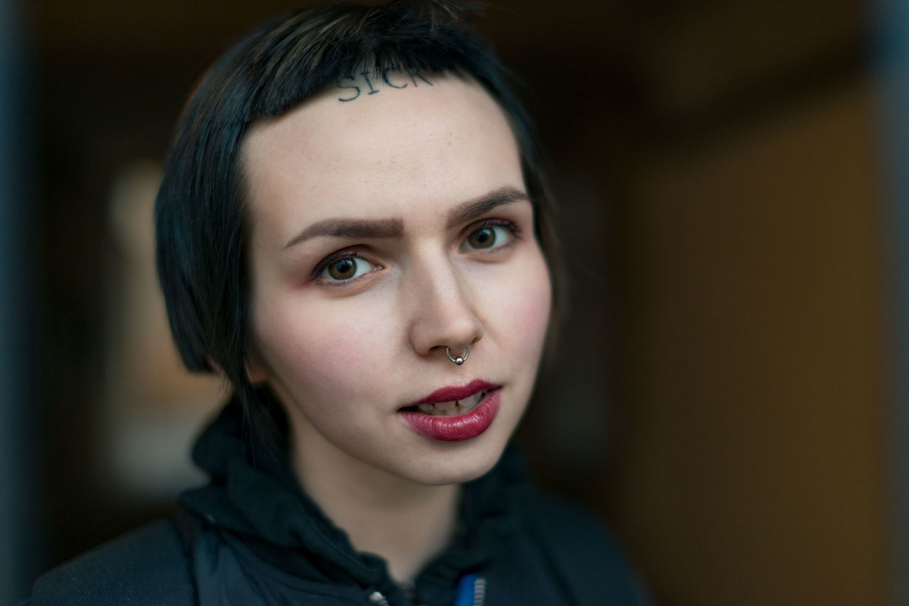 headshot, portrait, focus on foreground, one person, young adult, close-up, front view, looking at camera, lifestyles, real people, young women, indoors, beauty, beautiful woman, leisure activity, women, lipstick, human face, contemplation