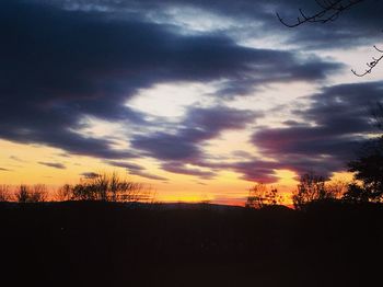 Scenic view of dramatic sky over silhouette landscape