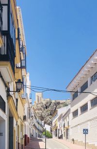 Low angle view of buildings against clear blue sky