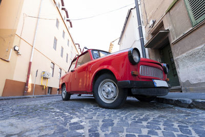 Car on street against buildings in city