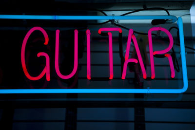 Rock music spirit, guitar, red neon sign 