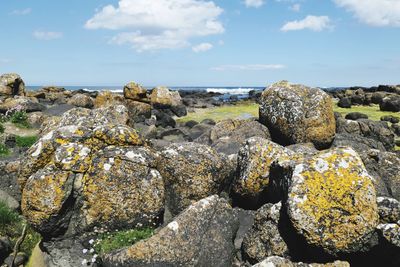 Rocks in sea against sky