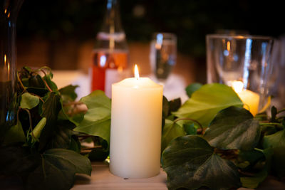 Close-up of illuminated candles on table