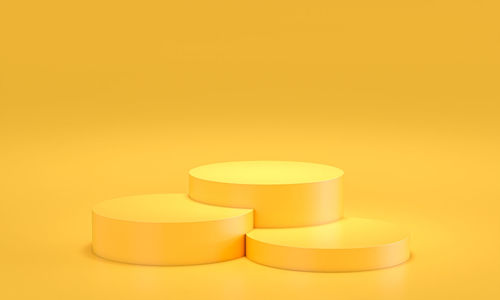 Close-up of yellow capsules over orange background